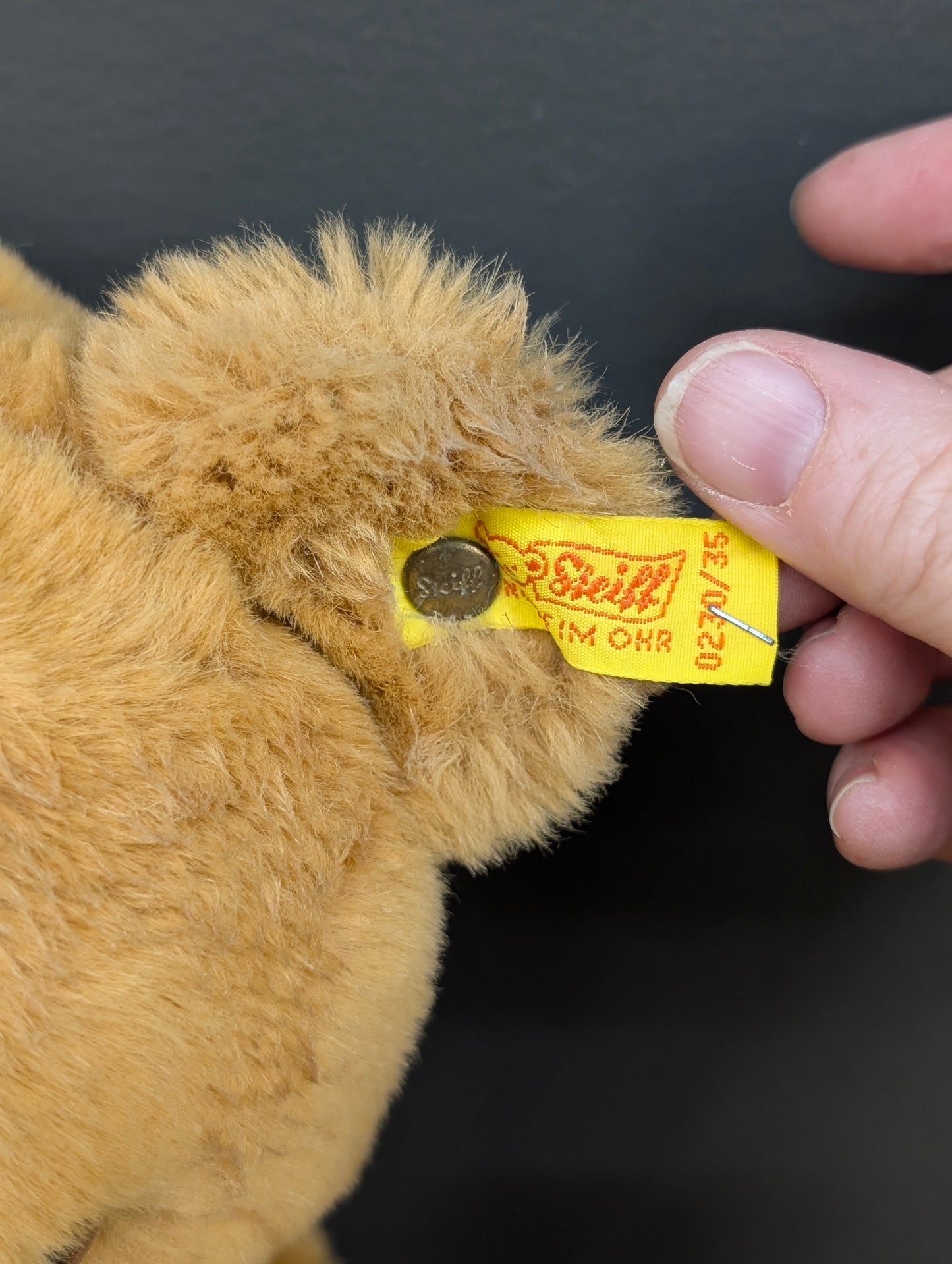 Steiff Petsy teddy bear with a red ribbon