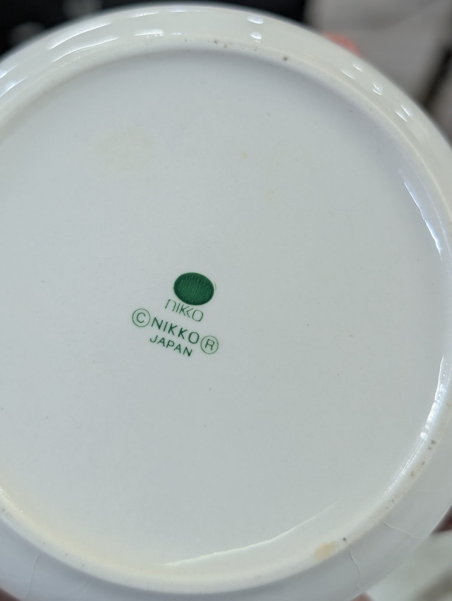 A vintage Nikko Fine China Christmas trinket box with a tree motif.