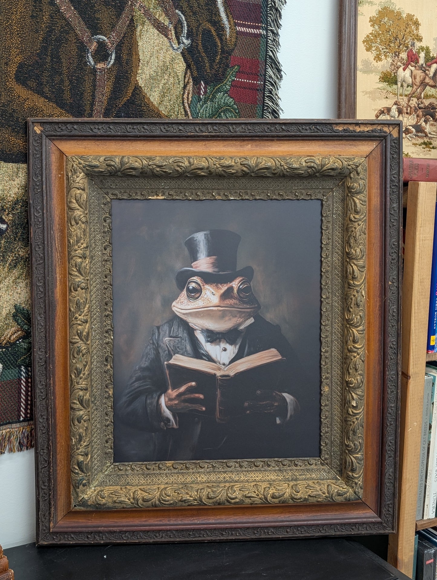 Frog reading in ornate frame