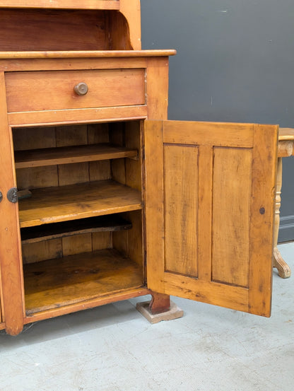 A two-piece Canadian pine cupboard with glass and solid doors