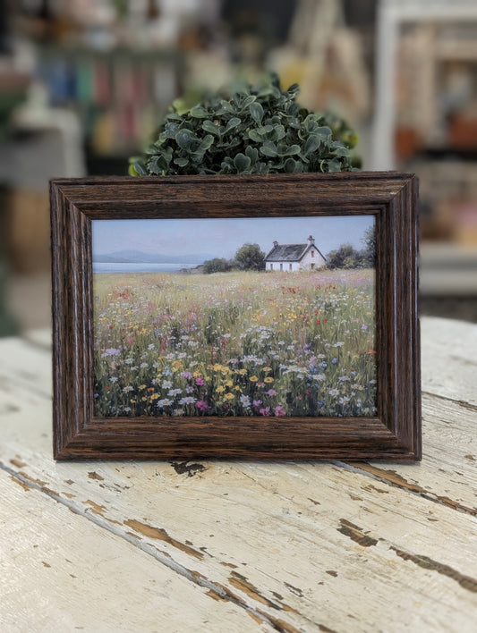 Framed print of field and cottage