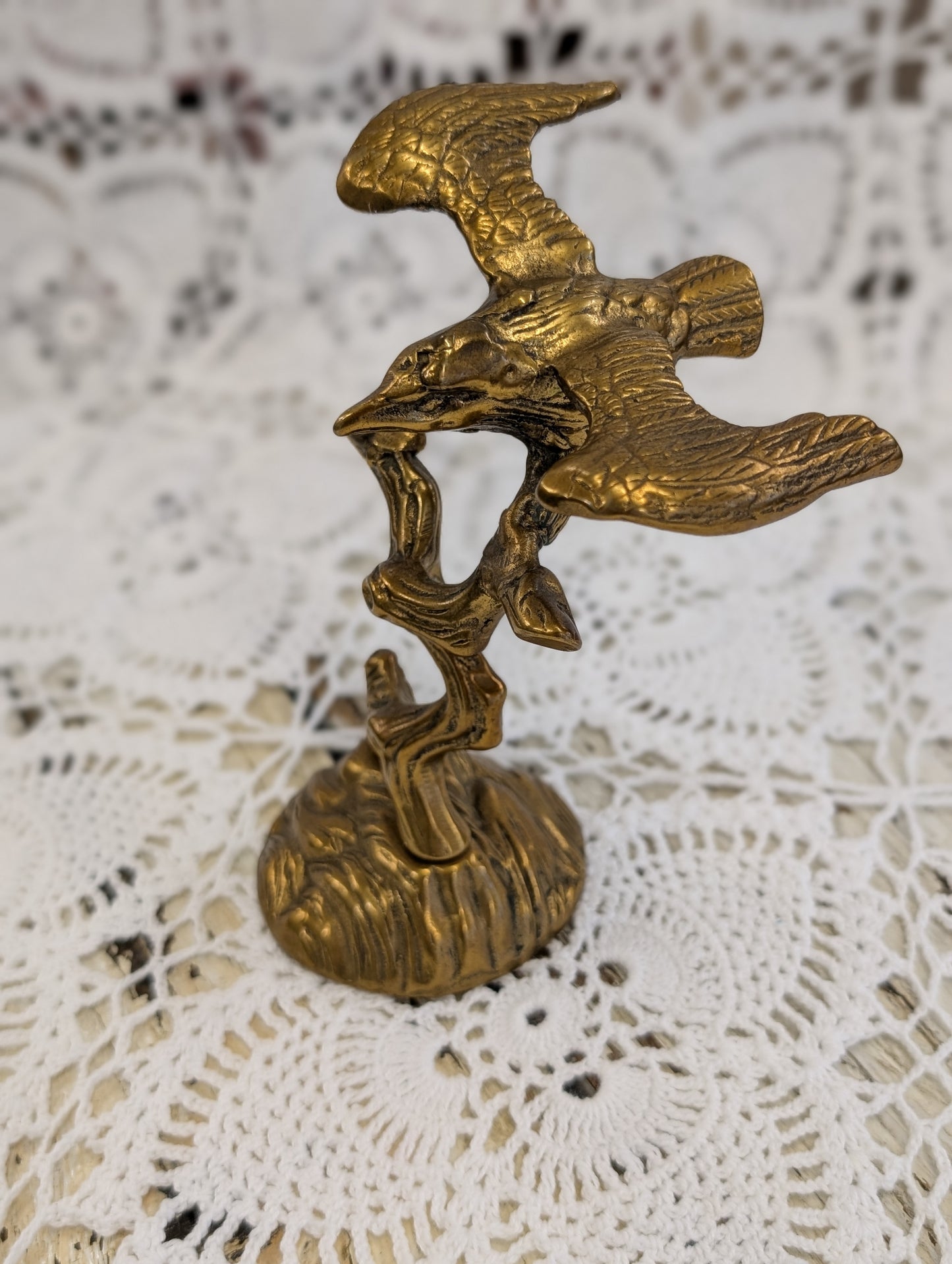 Brass bird on branch