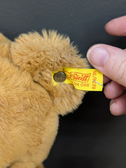 Steiff Petsy teddy bear with a red ribbon