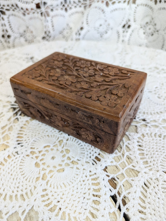 hand-carved wooden box with floral motifs