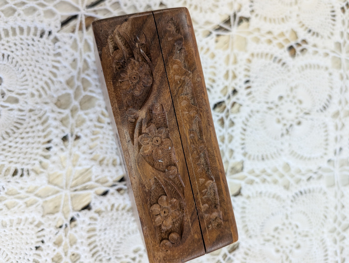 hand-carved wooden box with floral motifs
