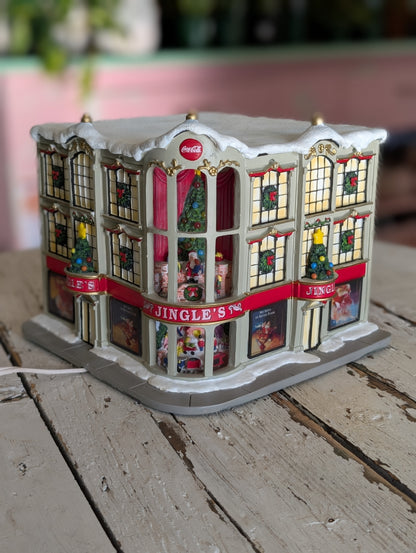 A lighted Coca-Cola Jingle's Department Store holiday village building