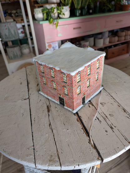 A lighted Coca-Cola Jingle's Department Store holiday village building