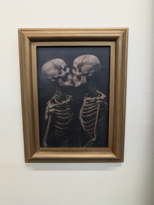 Kissing skeletons framed print