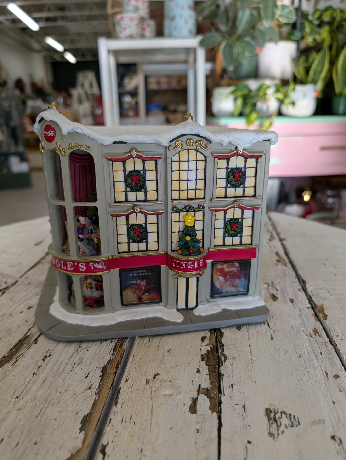 A lighted Coca-Cola Jingle's Department Store holiday village building