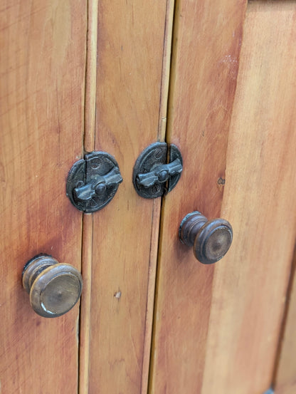 A two-piece Canadian pine cupboard with glass and solid doors