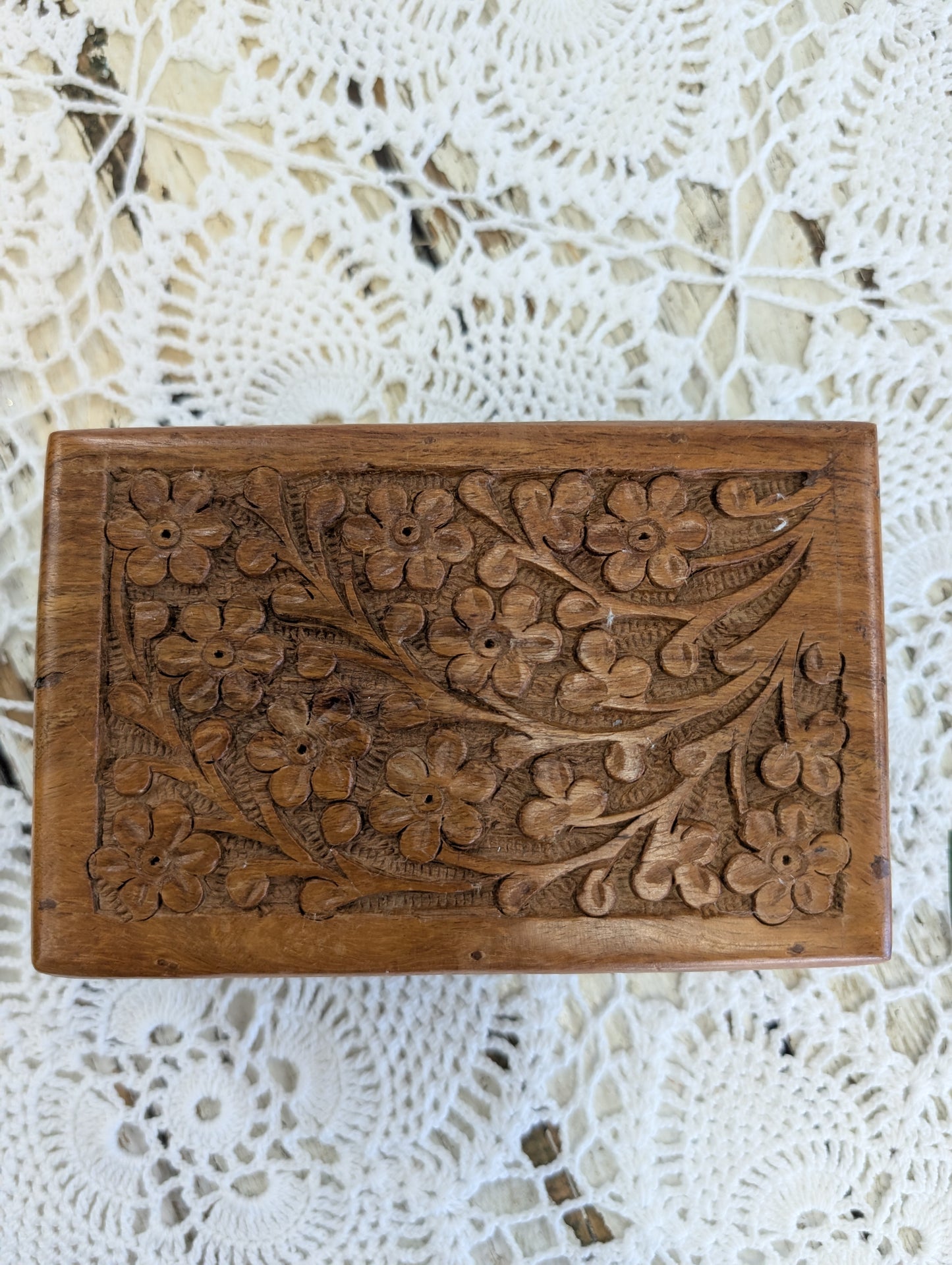 hand-carved wooden box with floral motifs