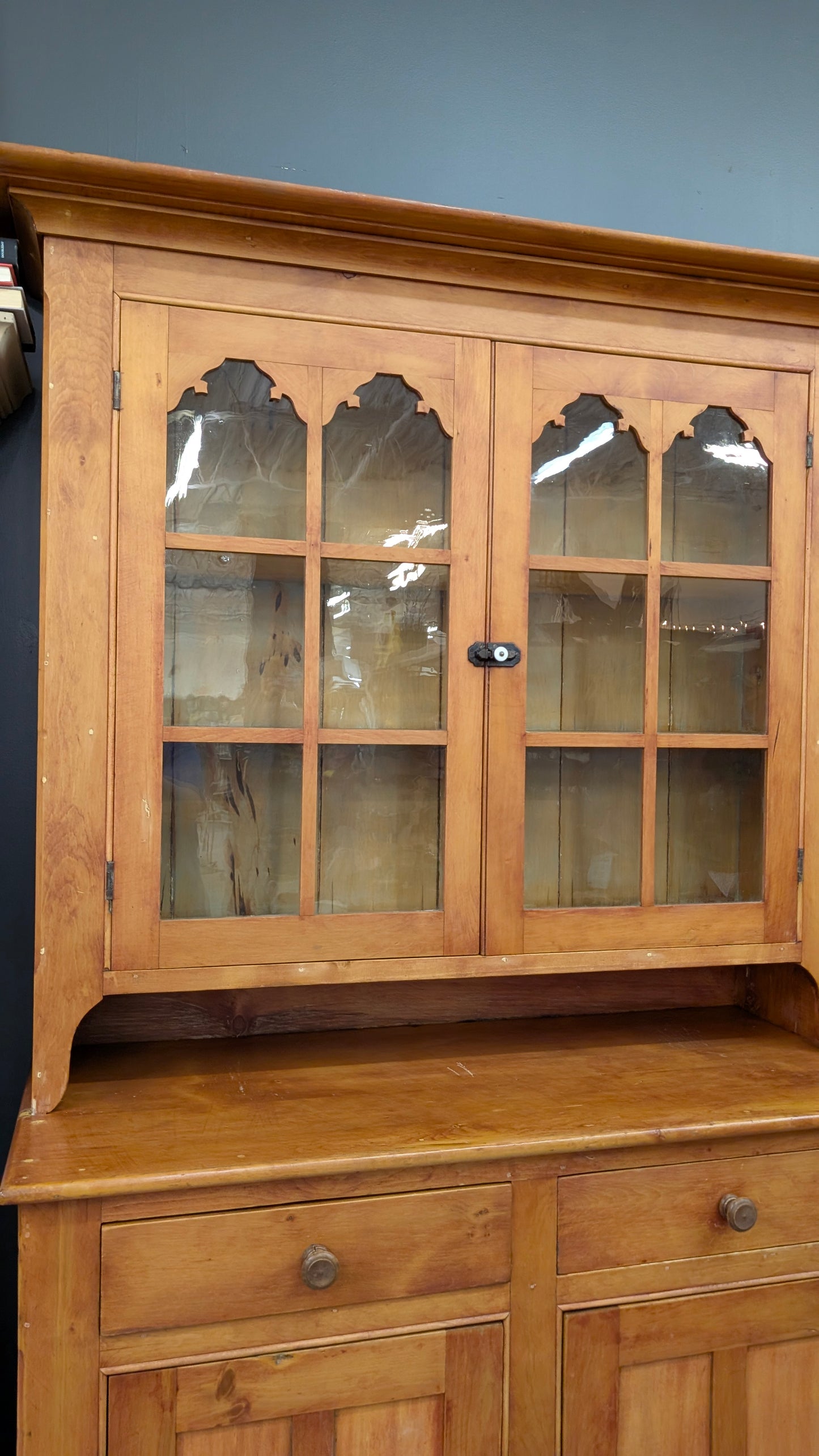 A two-piece Canadian pine cupboard with glass and solid doors