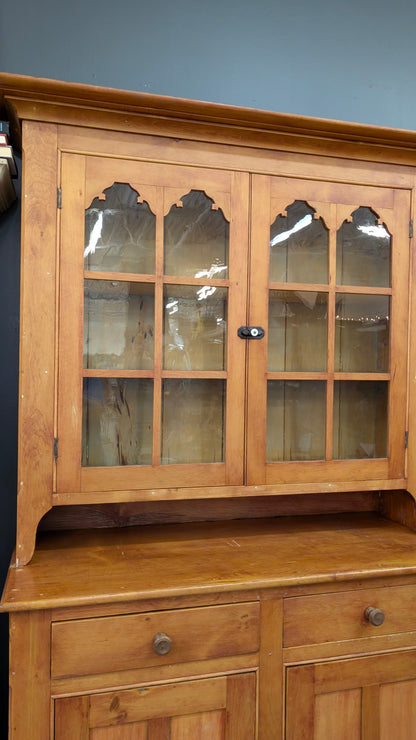 A two-piece Canadian pine cupboard with glass and solid doors