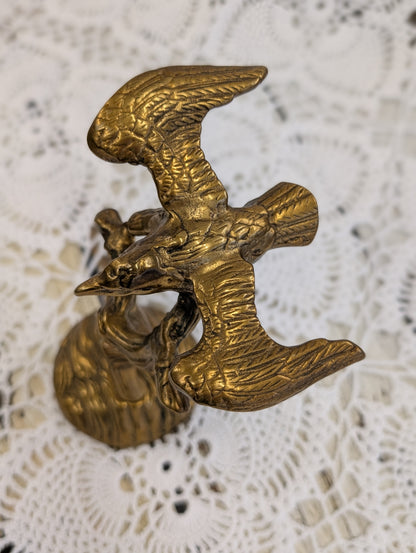 Brass bird on branch