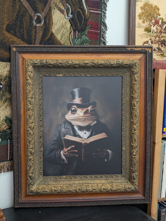 Frog reading in ornate frame