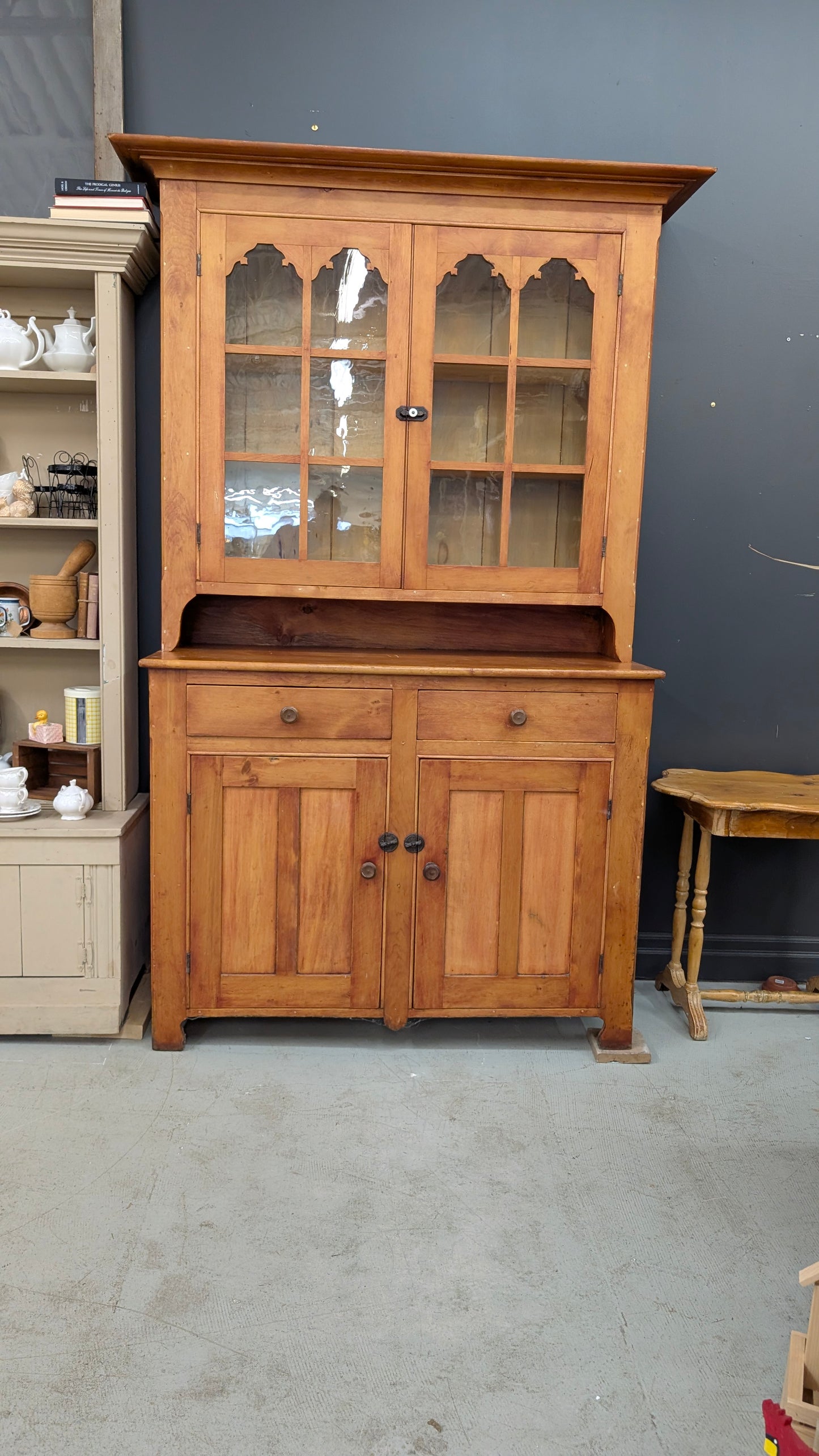 A two-piece Canadian pine cupboard with glass and solid doors