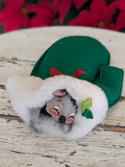Mouse hiding in a green mitten