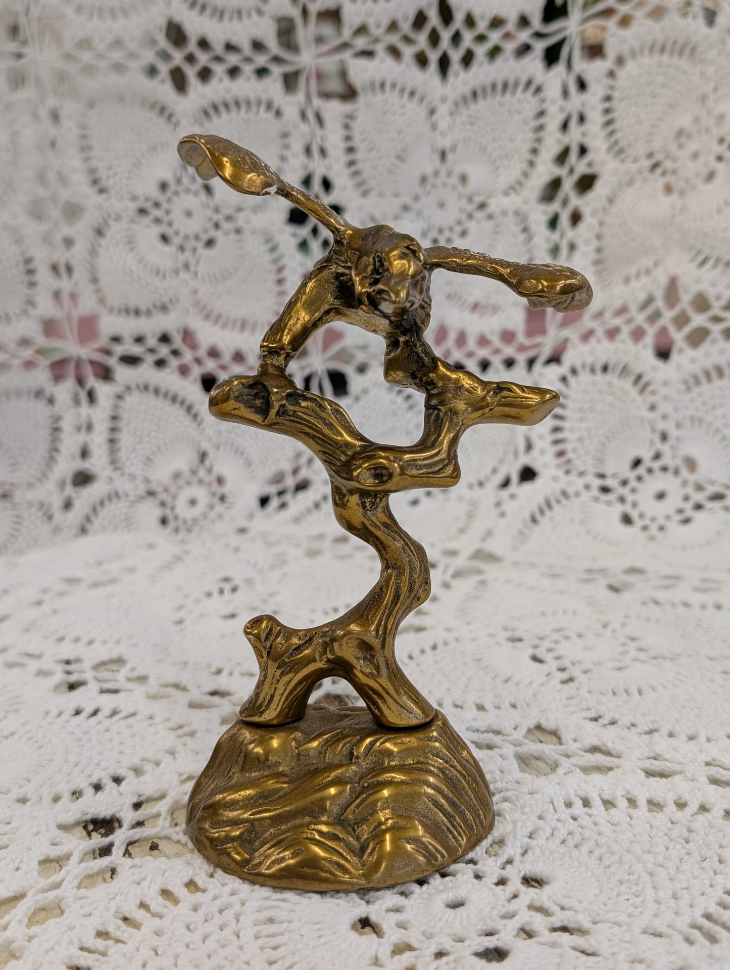 Brass bird on branch