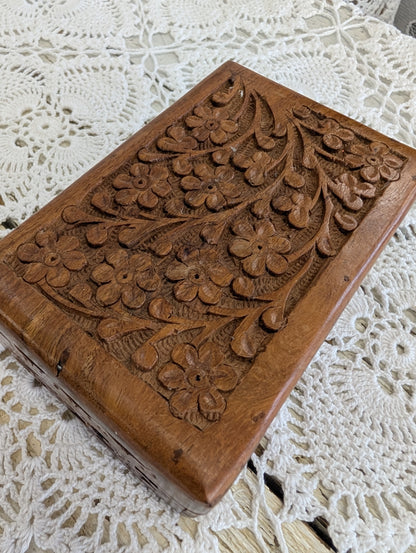 hand-carved wooden box with floral motifs